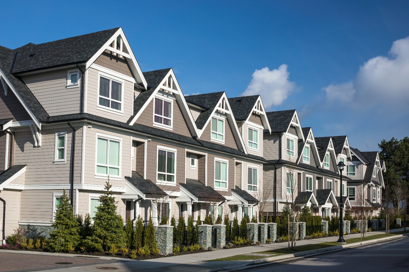 A row of houses on the side of a street.