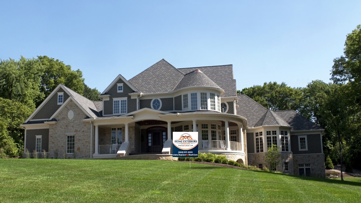 A large house with a sign on the front of it.